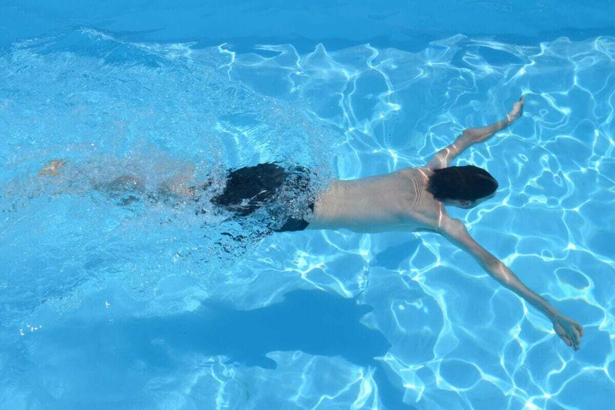 man in swimming pool underwater